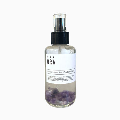 ora aromatherapy white light purification mist in glass bottle with amethyst crystals inside